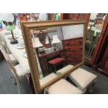 A large gilt framed bevelled mirror with egg and dart border to frame,