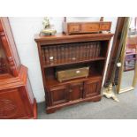 An old charm style bookcase with two cupboard door base,