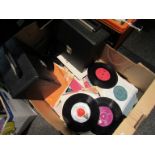 A box and two cases of 7" singles