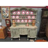 An imbuia wood five drawer and two door dresser with three tier gallery top in distressed paint
