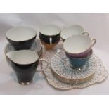 A Royal Grafton part tea set, black and gilt saucers and dishes with multi-coloured cups,