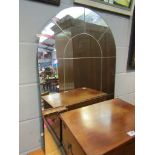 An arch top over mantel mirror, one pane loose,