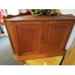 A small oak two door wall hagning corner cabinet