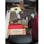 A box of mixed items including Caley's sweet boxes, dominoes, prints, fans, flatware,