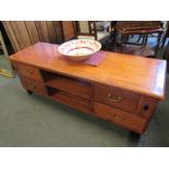 A modern hardwood four drawer TV unit,