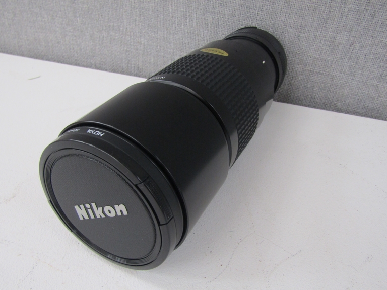 A Nikon Nikkor 300mm zoom lens, serial no.