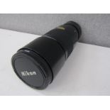 A Nikon Nikkor 300mm zoom lens, serial no.