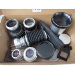 A box containing a collection of lenses including Yashica and Franke & Heidecke