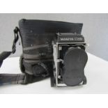 A cased Mamiya C220 medium format camera,