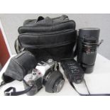 A selection of photographic accessories including Canon AV-1 SLR camera etc