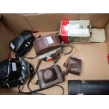 A box of mixed cameras including Voigtlander Vito B