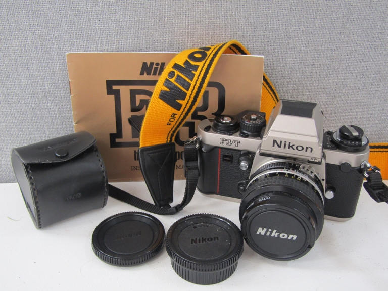 A Nikon F3/T Titanium SLR camera with 50mm lens and manual