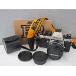 A Nikon F3/T Titanium SLR camera with 50mm lens and manual