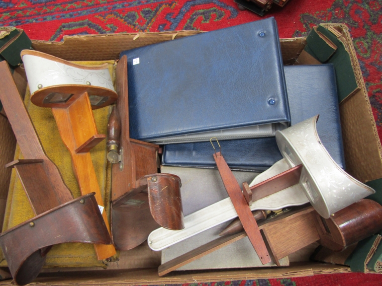 A quantity of stereoviewers for repairs together with slide boxes and two empty albums