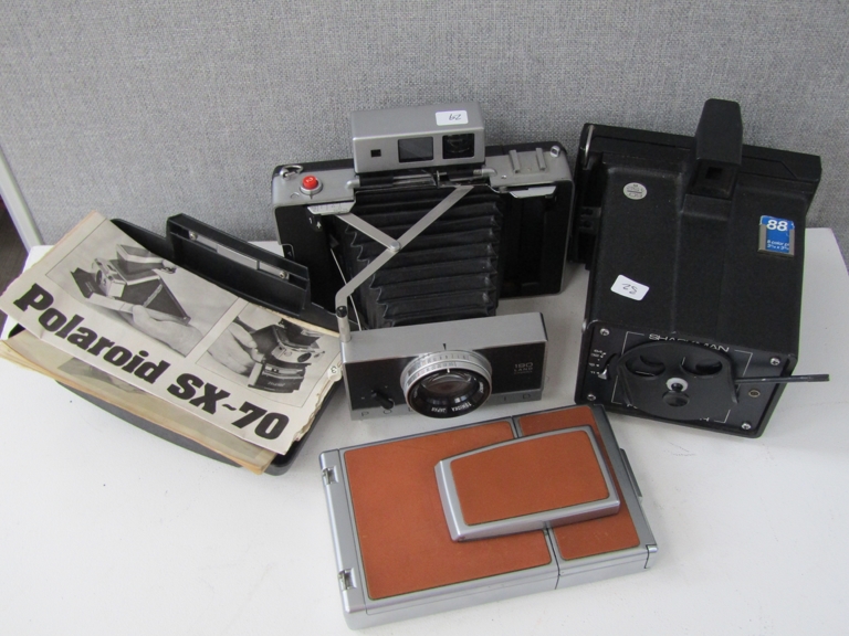 Three Polaroid cameras including Land 190