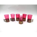 A set of six cranberry glasses with pierced cherubic holders