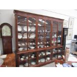 A late Victorian walnut library bookcase, the lunette crest over six door to and base,