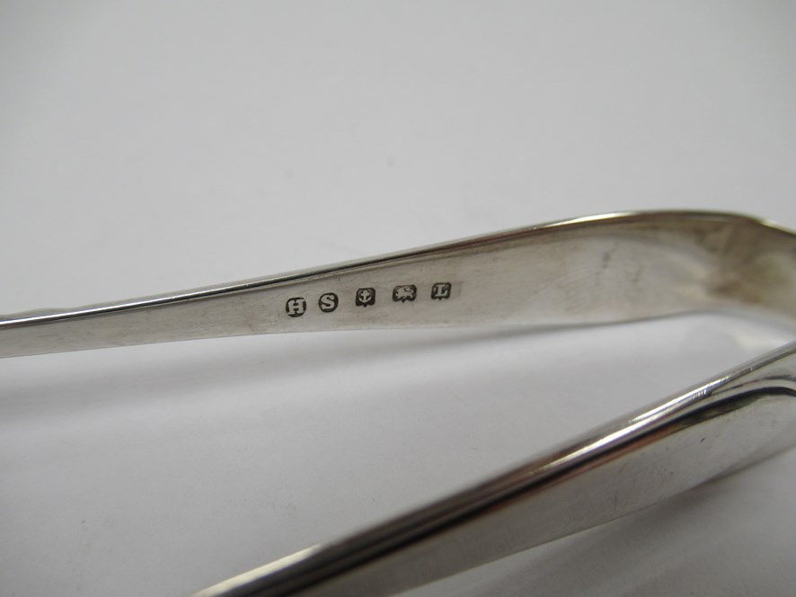 Two pairs of silver sugar tongs including Georgian bright-cut design together with a stirrup - Image 2 of 4