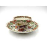 A First Period Worcester "Bishop Summer" pattern tea bowl and saucer