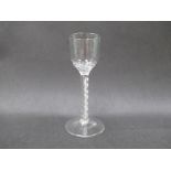 A mid 18th Century wine glass with honeycomb and wrythen moulding to the base of the ogee bowl,