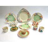 Three Clarice Cliff plates, egg cups,