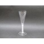 A mid 18th Century ale glass with funnel shaped bowl raised upon a double series opaque twist stem