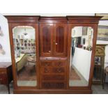 A late Victorian / early Edwardian mahogany compactum wardrobe with central cupboard and drawers,