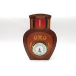 An Oxo advertising aneroid barometer in the form of a jar of Oxo,