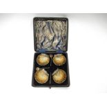 A cased set of four silver gilt salts in the form of shells, all spoons a/f, in fitted case,