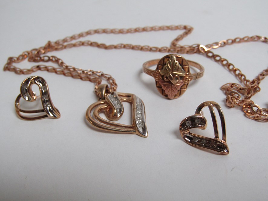 A pair of gold and diamond heart shaped earrings and matching pendant stamped 10k hung on a 9ct - Image 2 of 2