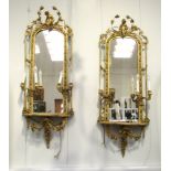A pair of 19th Century gilt gesso girandole wall mirrors,