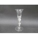 A mid 18th Century wine glass with bell shaped bowl set on a shoulder knop with central knop to the