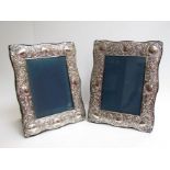 A pair of silver embossed easel backed photograph frames, Birmingham, 32cm x 24.
