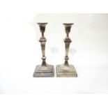 A pair of William Hutton and Sons silver candlesticks, marked London 1901. 29.5cm high.