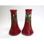 Two Minton successionist ware vases. 25cm high.
