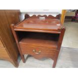 A George III mahogany nightstand with galleried back and single drawer below alcove.