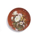 A large burnt orange coloured charger with floral detailing, marks to back.