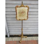 A 19th Century gilt wood fire screen on gilt brass and carved tripod base, silk embroidered panel,