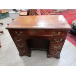 An 18th Century and later mahogany kneehole desk, eight drawers and recessed door,