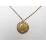 A 1908 gold sovereign in 9ct gold heart pierced mount, on 9ct chain,