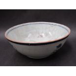 A 19th Century Oriental blue and white oversized bowl with mountainous scenes and dwellings,