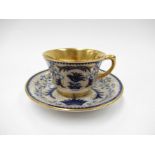 An Arabia of Finland gilded porcelain "She-Foo" demitasse cup and saucer designed by Greta-Liisa
