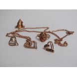 A pair of gold and diamond heart shaped earrings and matching pendant stamped 10k hung on a 9ct
