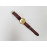An Omega Geneve 9ct gold cased manual wind wristwatch on brown leather strap