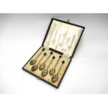 A cased set of silver and multi-coloured guilloche enamel coffee spoons,