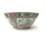 A 19th Century Japanese oversized bowl with all-over polychrome floral sprays and interior scenes.