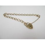 A 9ct gold charm bracelet with heart shaped lock, 5.