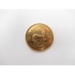 A 1980 South African Krugerrand with Chartered Bank plastic case