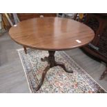 A Georgian mahogany tilt top occasional table with turned vase form column to tripod base,