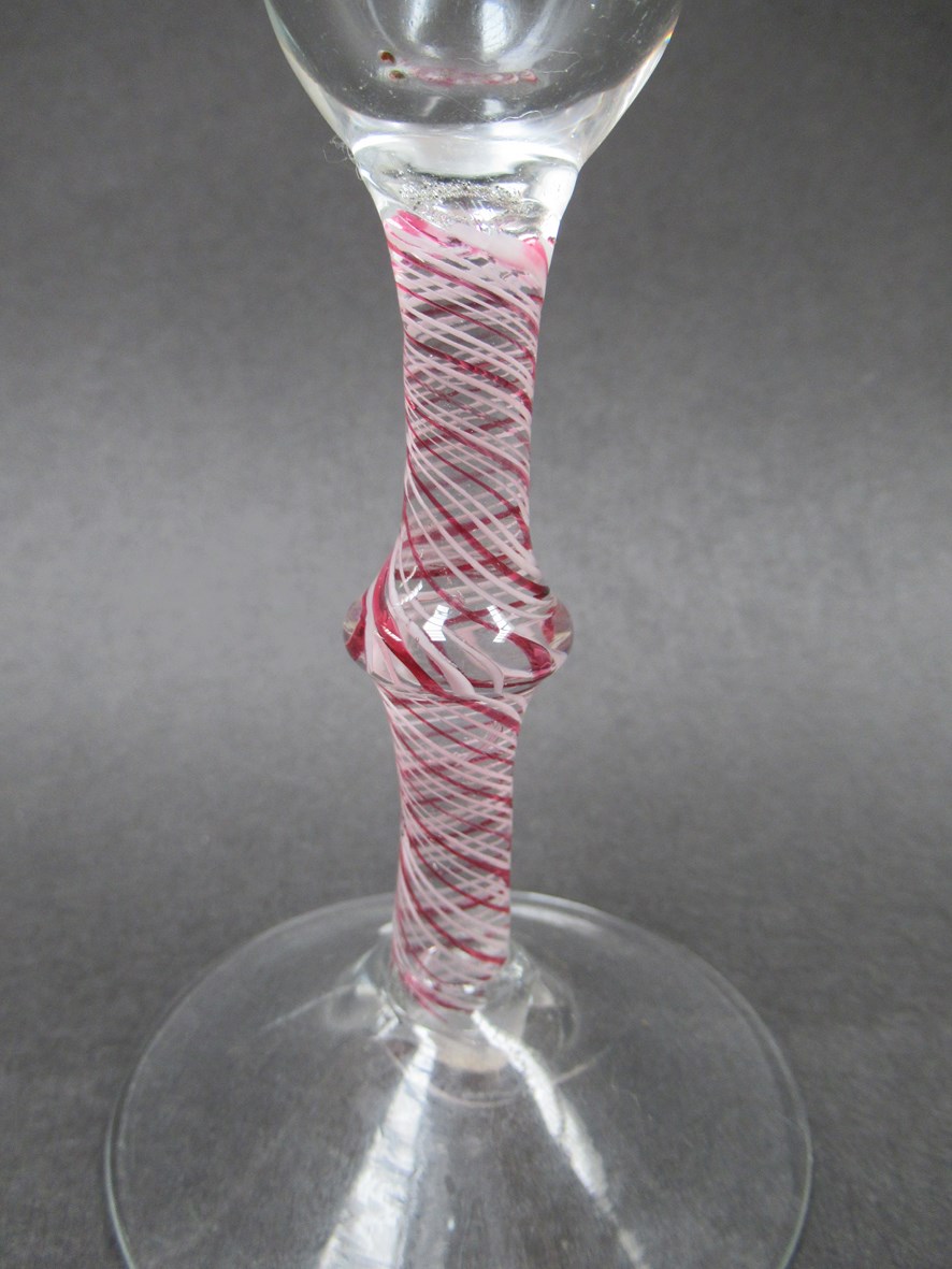 An 18th Century wine glass with bell shaped bowl on a knopped opaque white and red spiral twist - Image 2 of 3